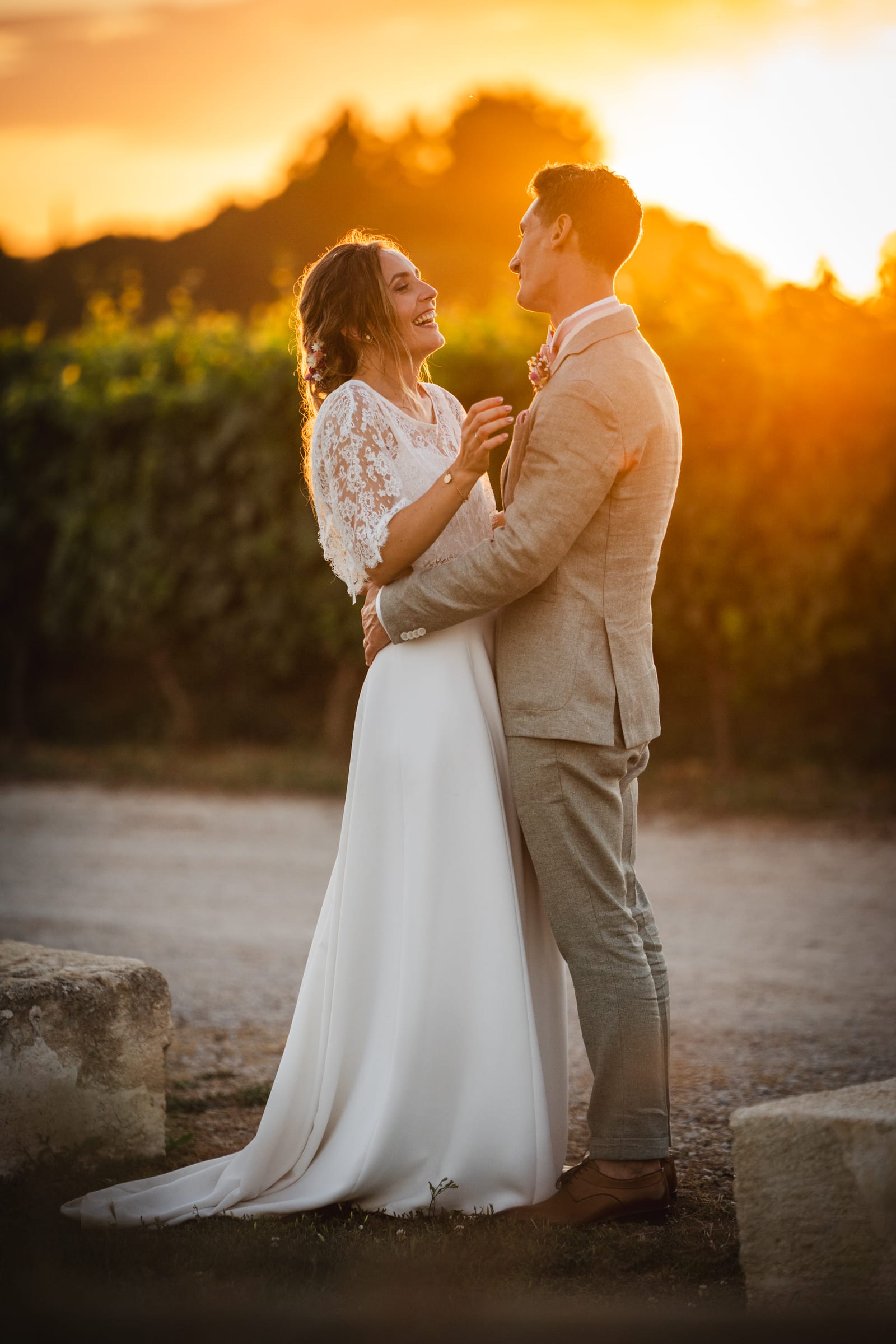 Wedding couple standing face to face at sunset, warm golden hour light in the South of France