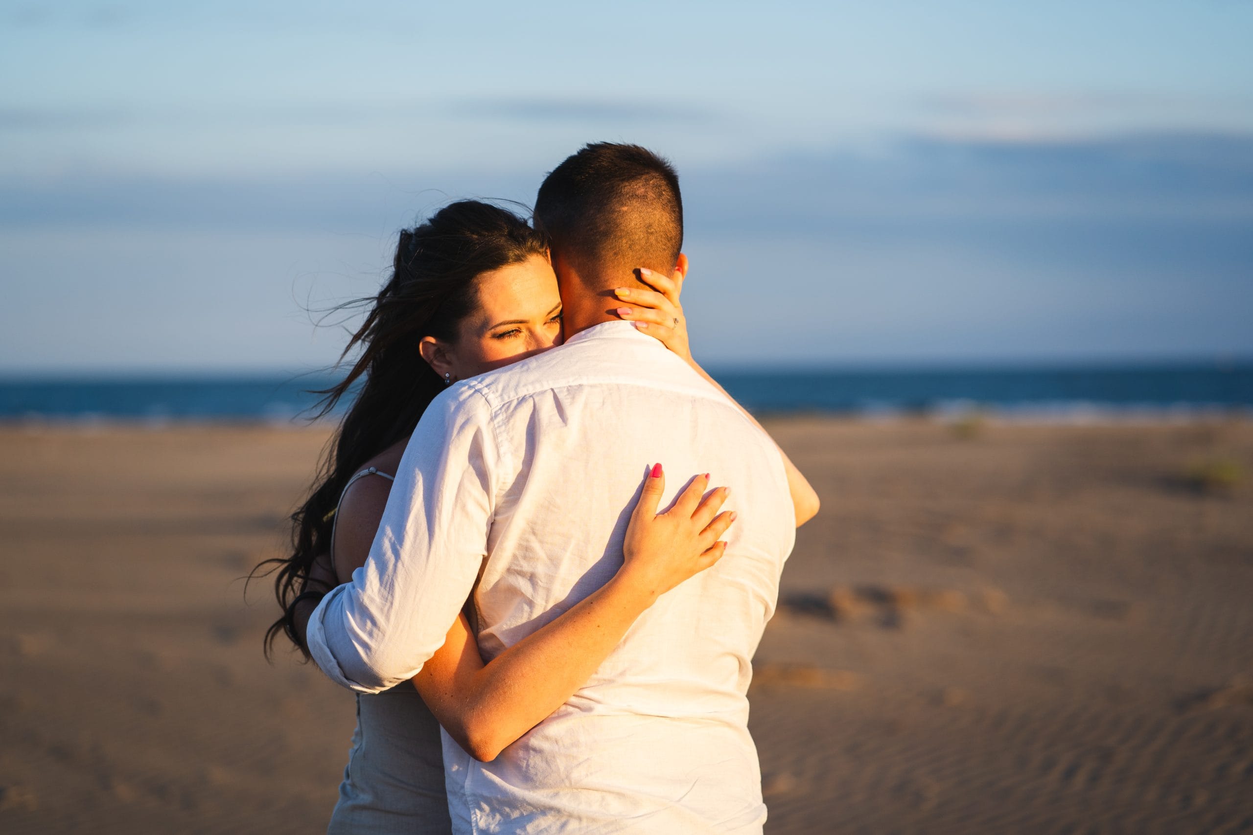 Couple embracing during a beach engagement session in the South of France