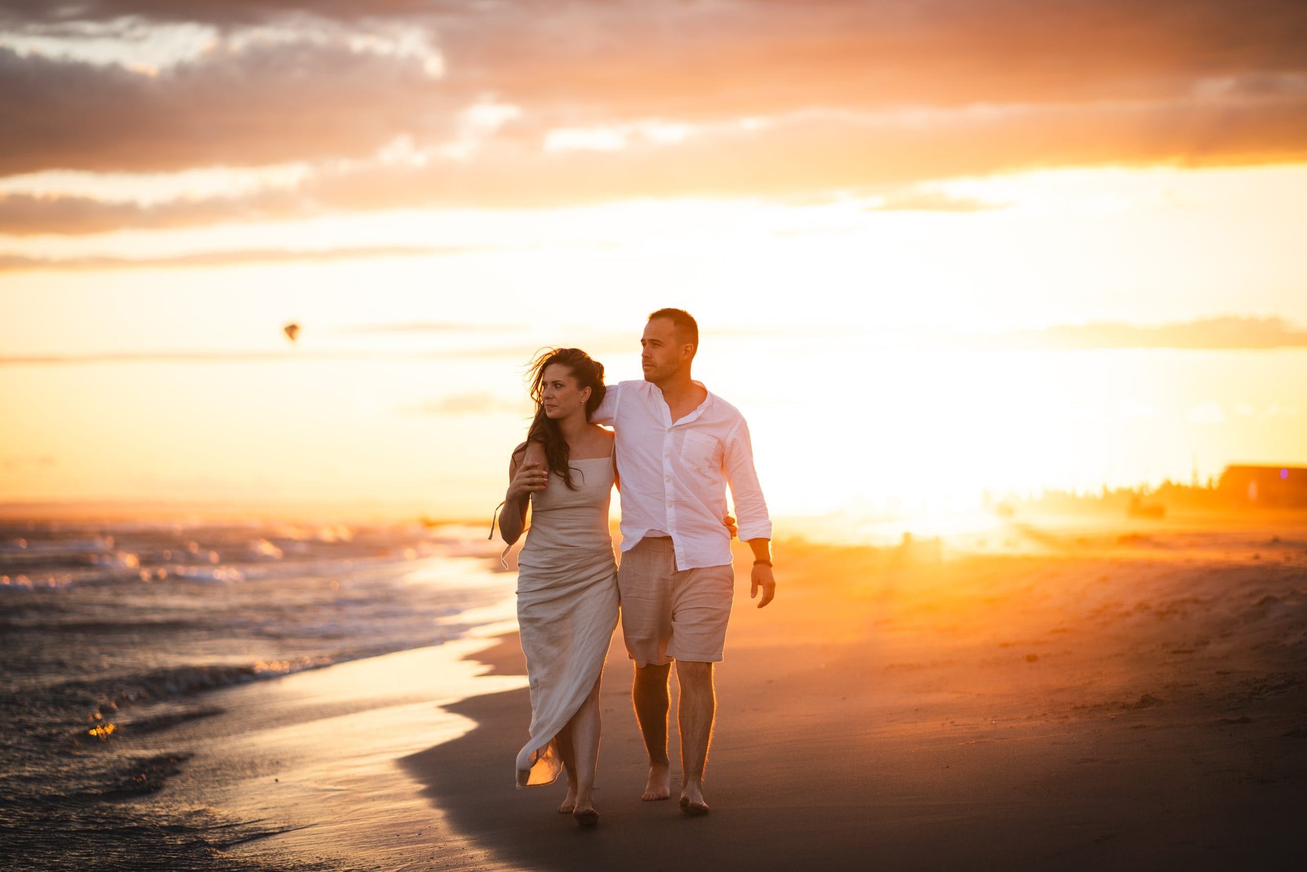 Couple walking on the Espiguette beach during their Mediterranean engagement session