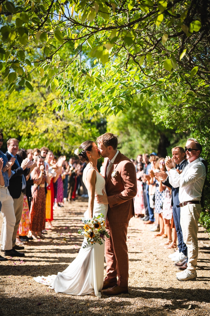 Bride and groom kissing under natural light after the ceremony – documentary and timeless wedding photography in South of France.