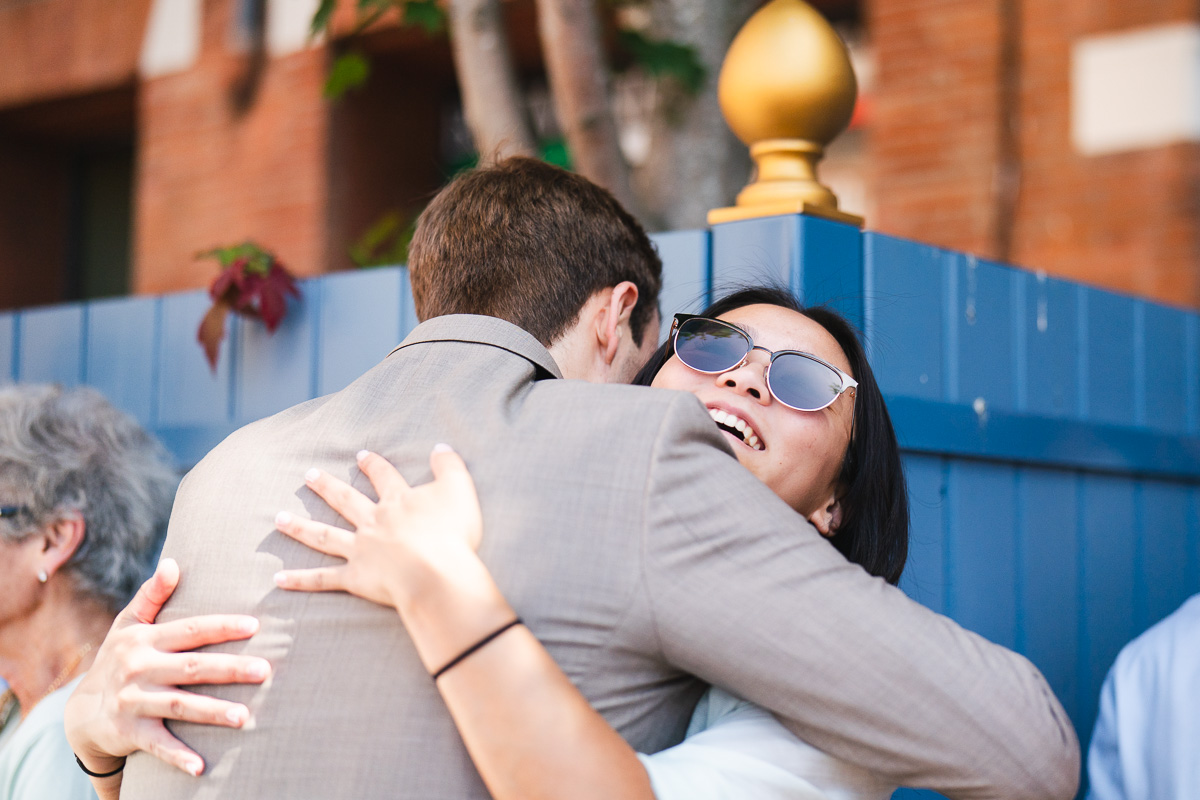 The groom embracing a friend on the Place du Capitole in Toulouse