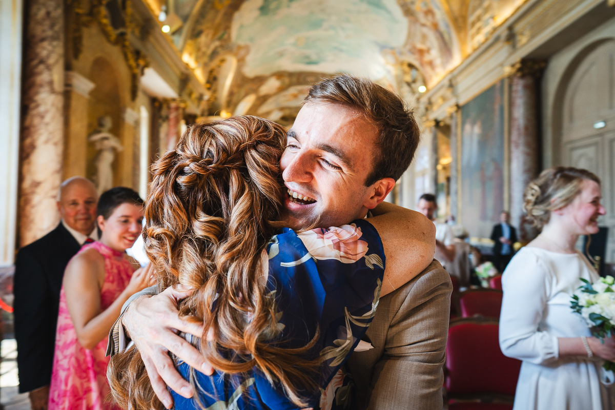 The groom embracing his mother after the civil ceremony at the Capitole de Toulouse