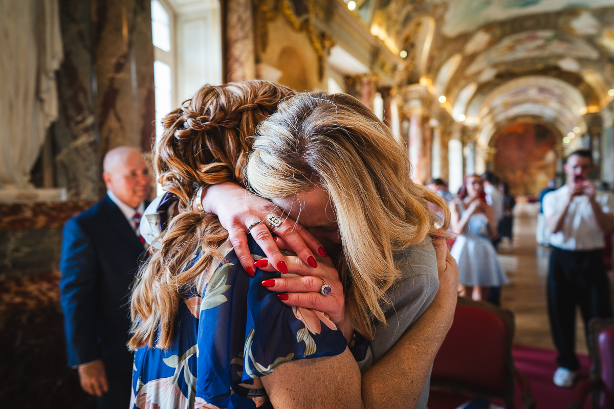 The mothers of the bride and groom embracing after the ceremony at the Capitole de Toulouse