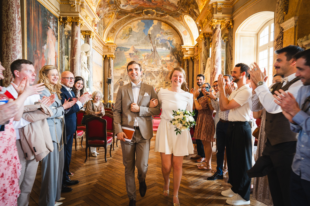 The couple leaving the Salle des Illustres to the applause of their guests