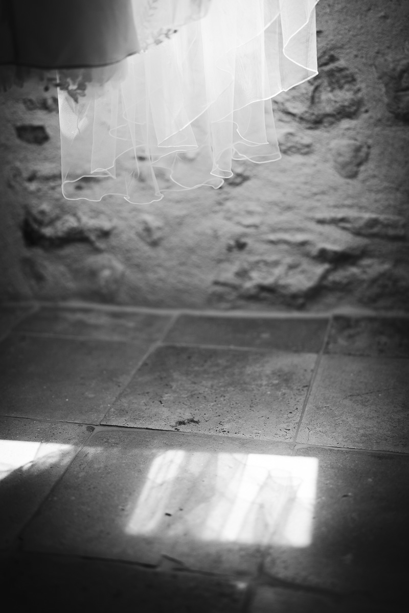 The bride's dress hanging during preparations at La Bélonie, Tarn