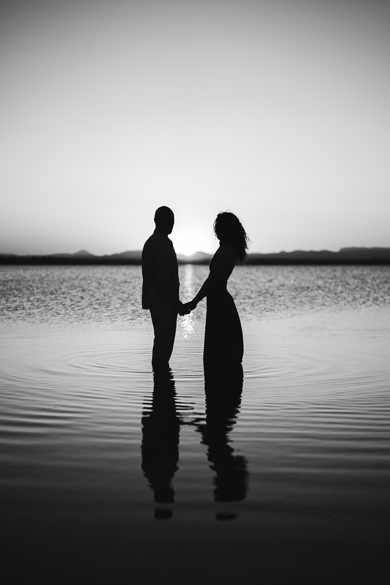 Black and white couple ankle-deep in the water, Étang de Canet, Pyrénées-Orientales