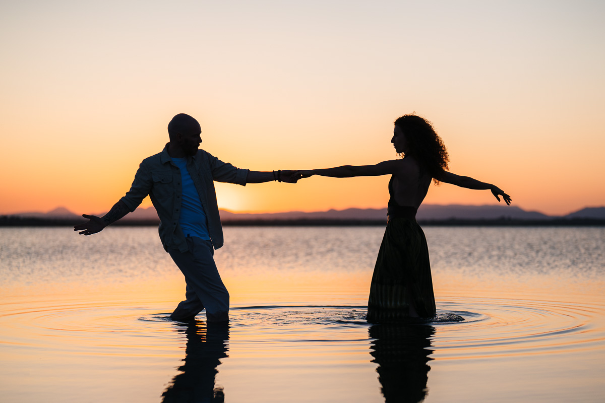 Golden hour at the Étang de Canet, couple ankle-deep in the water, Pyrénées-Orientales