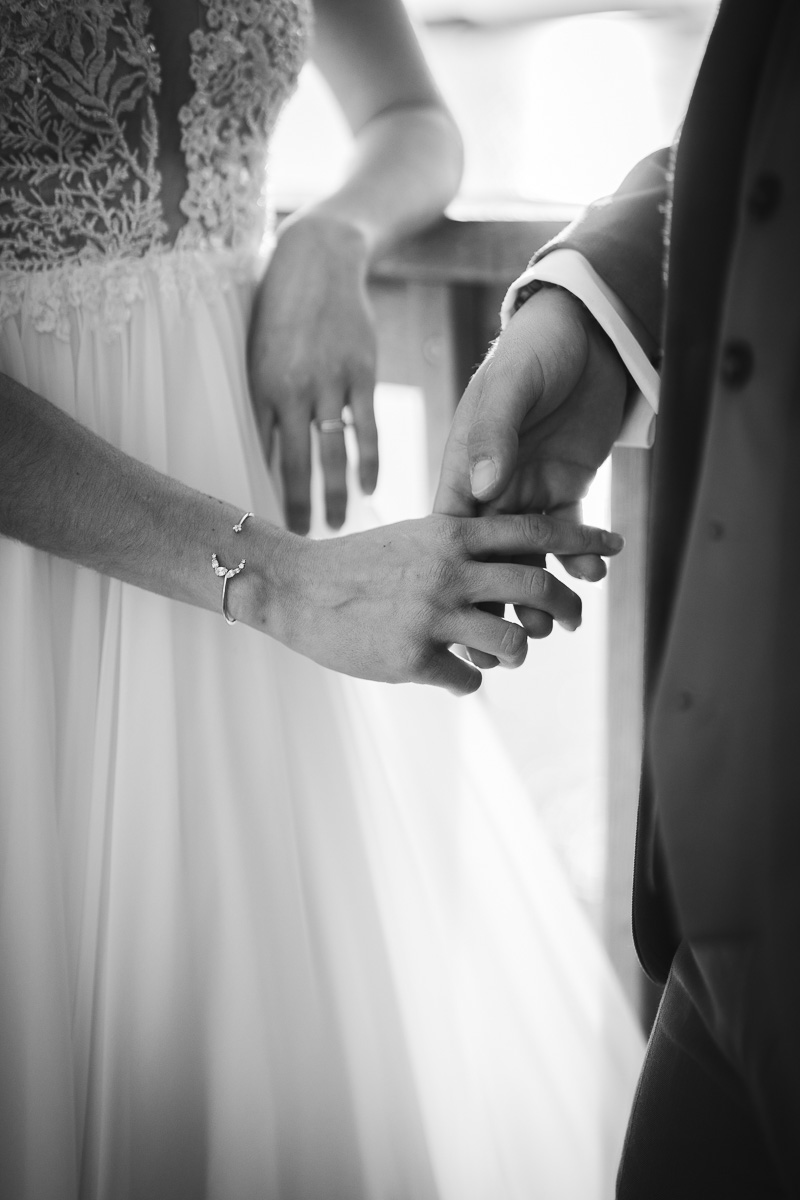 Married couple holding hands during a day after session in Camargue, hands detail
