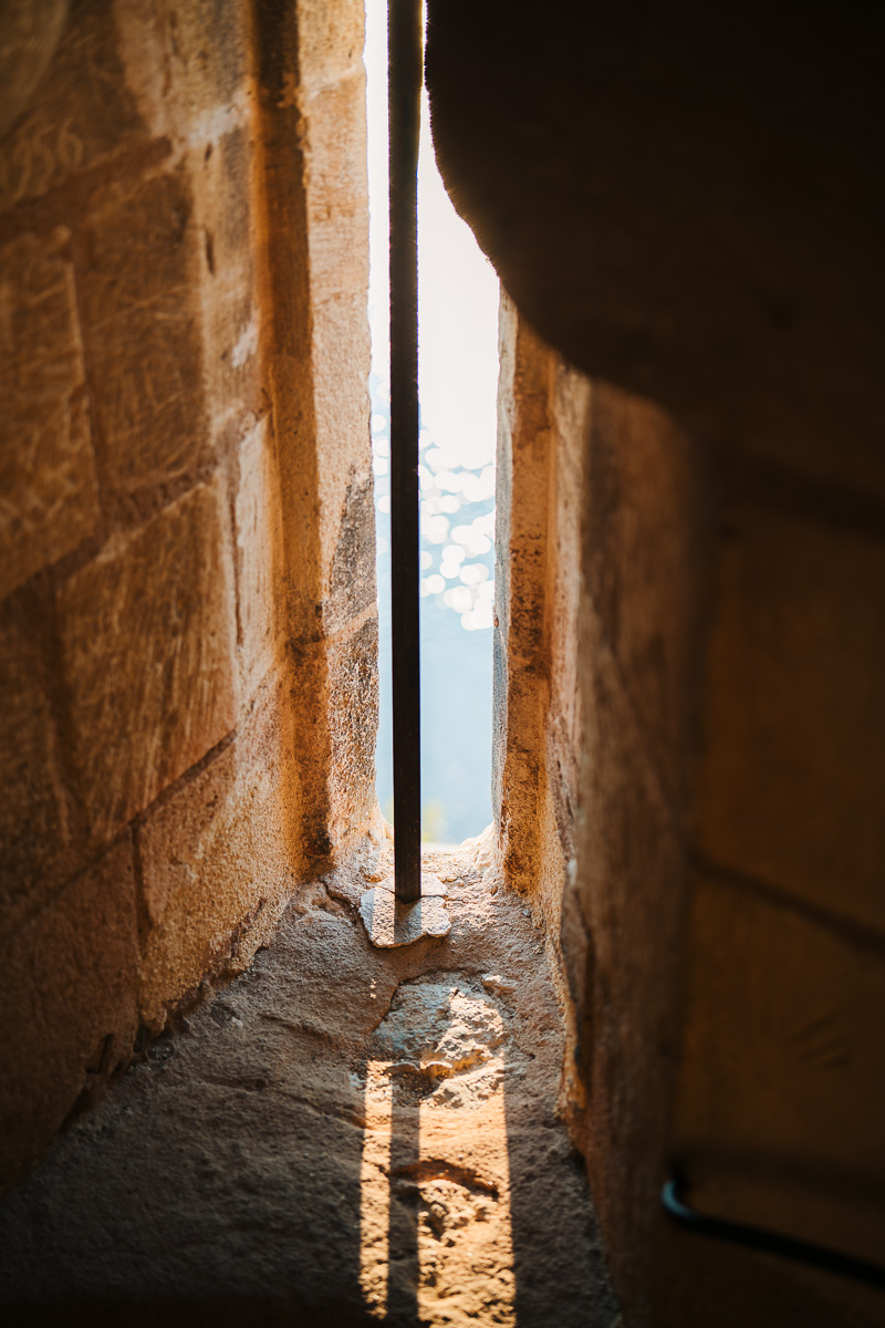 ``` Golden light beam through a narrow opening of Tour Carbonnière ```