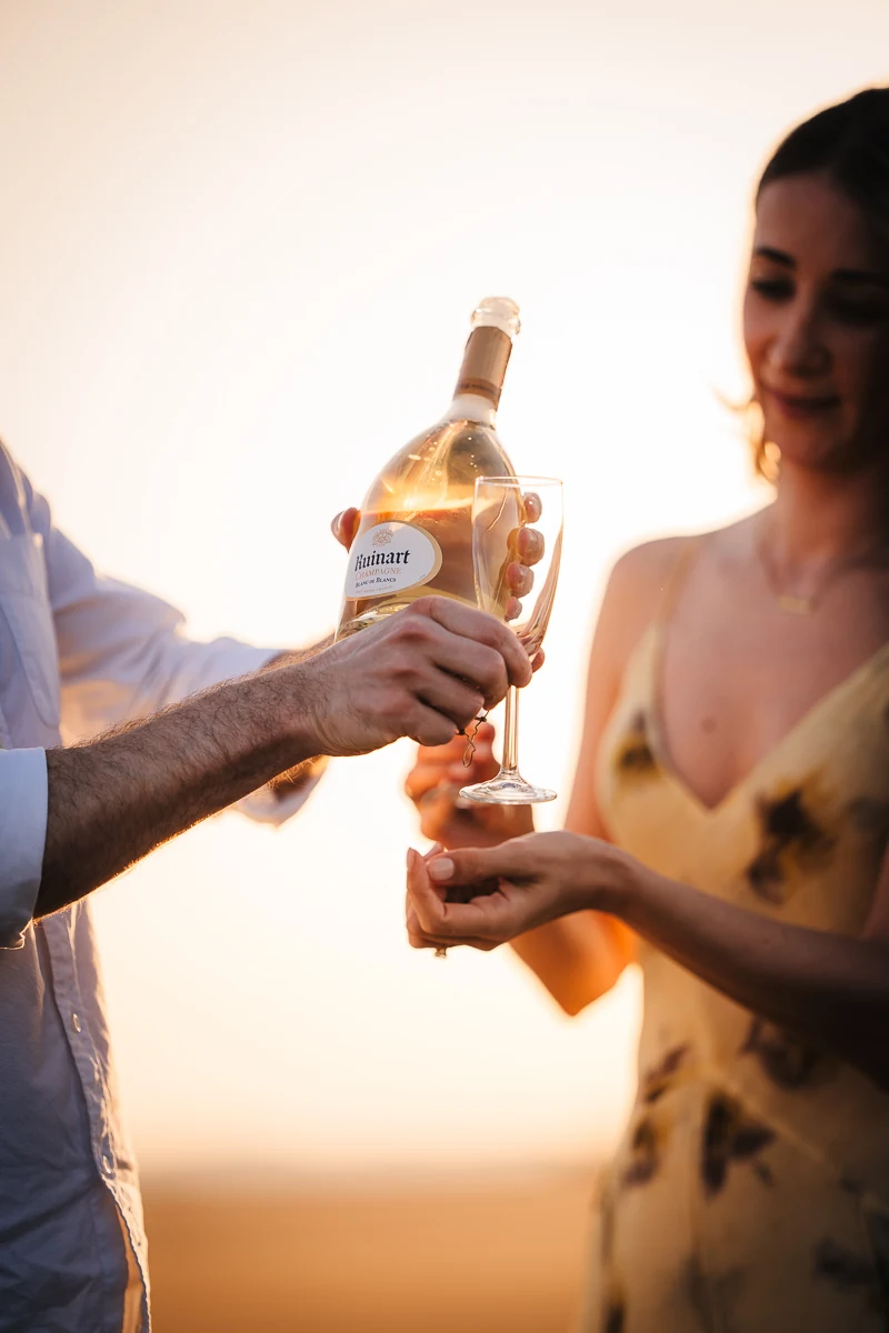 Close-up of a bottle of Ruinart Blanc de Blancs champagne in a lavender field