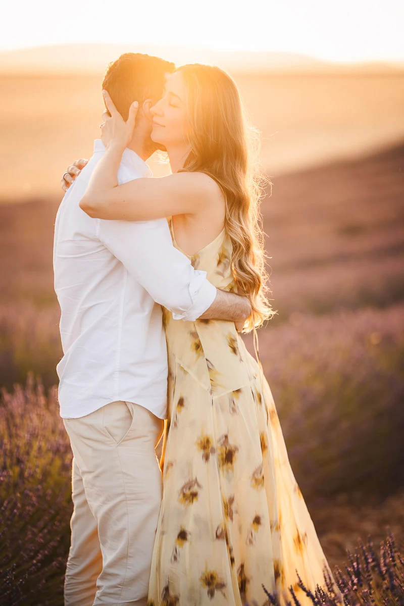 A couple embracing in a lavender field, close framing