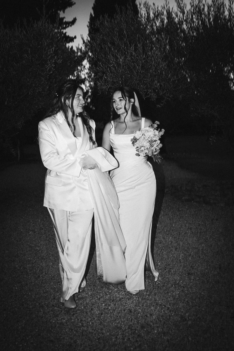 Black and white flash portrait of two brides during an evening wedding photo session
