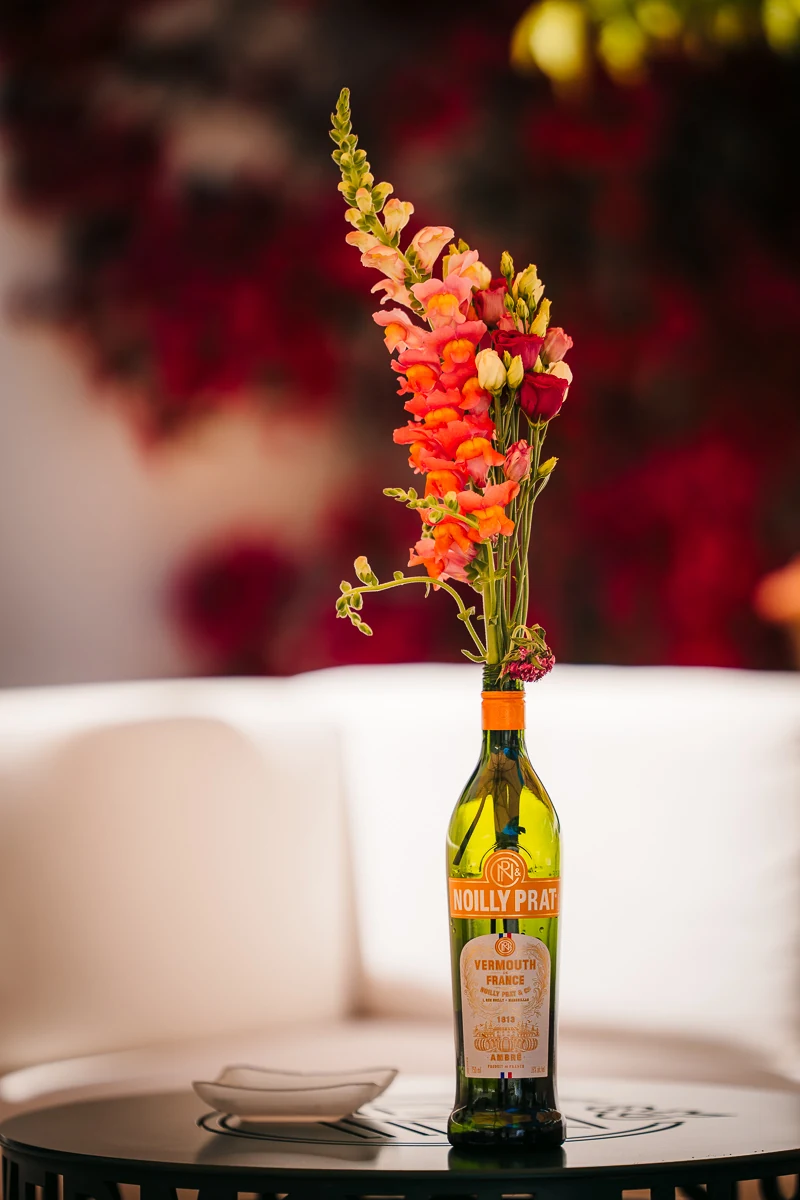 Wine bottle and red flowers on a table