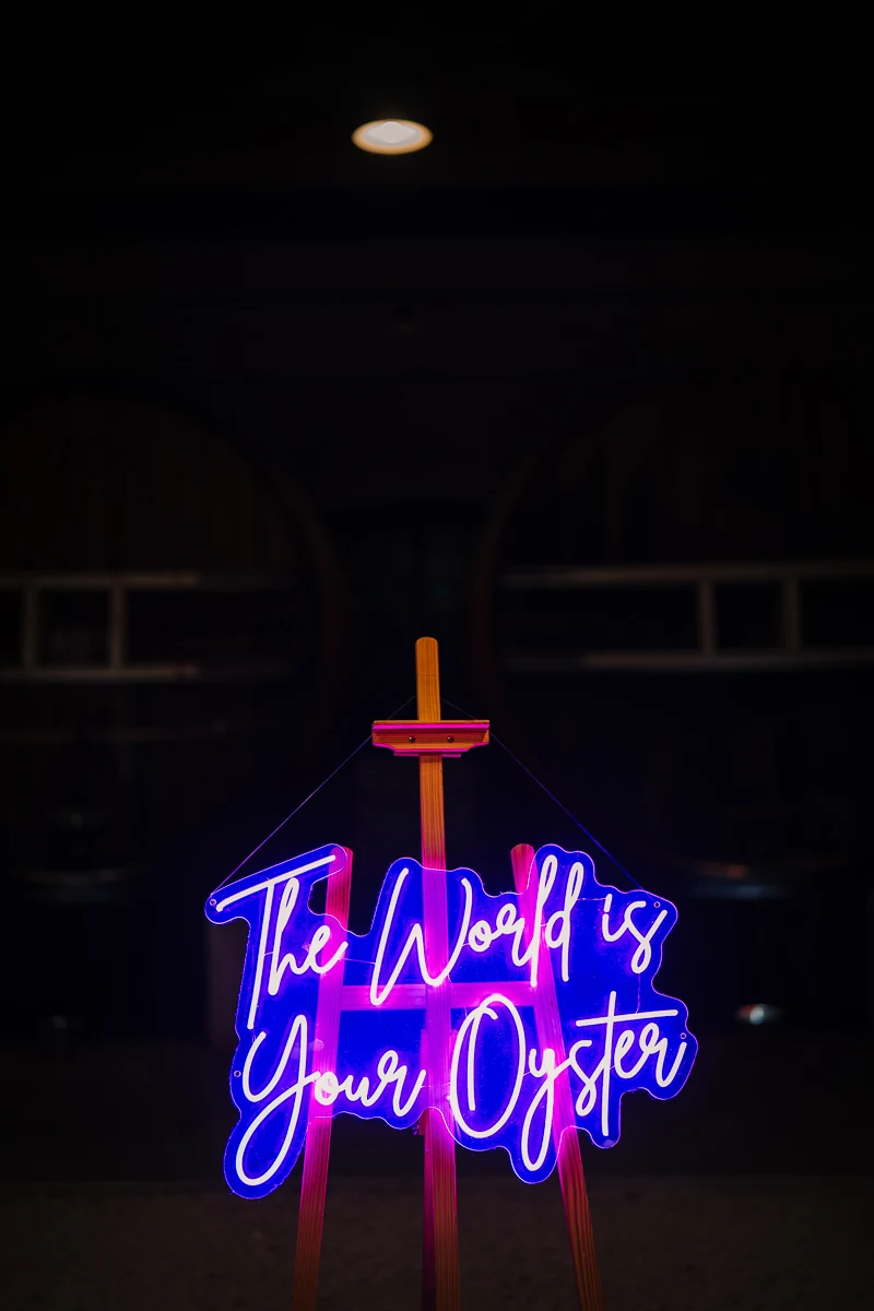eon sign reading The World Is Your Oyster at the wedding venue