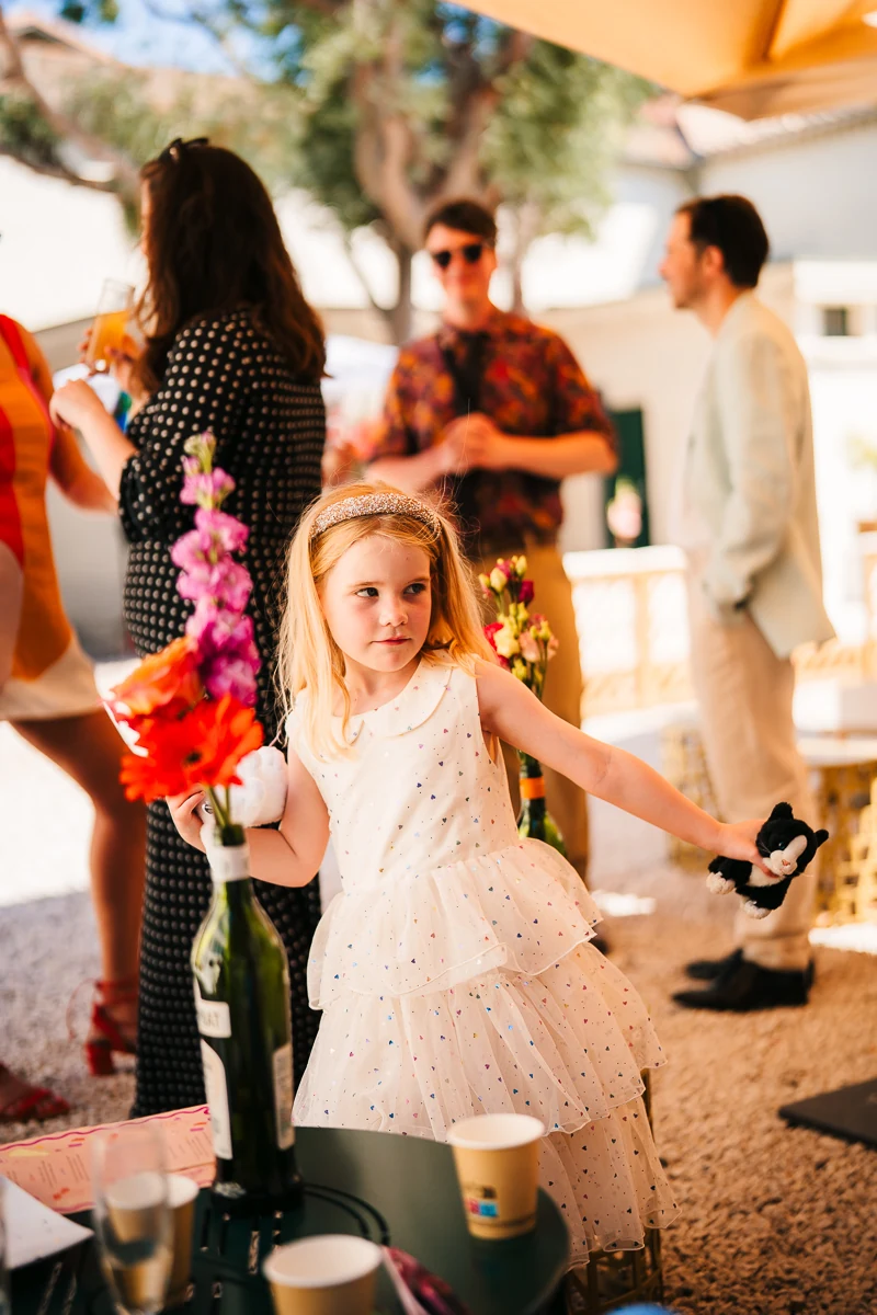 Young girl walking with a flower crown among the guests