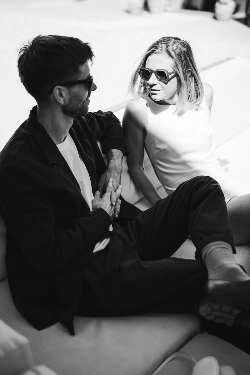 Black and white portrait of a couple sitting together - sun shade