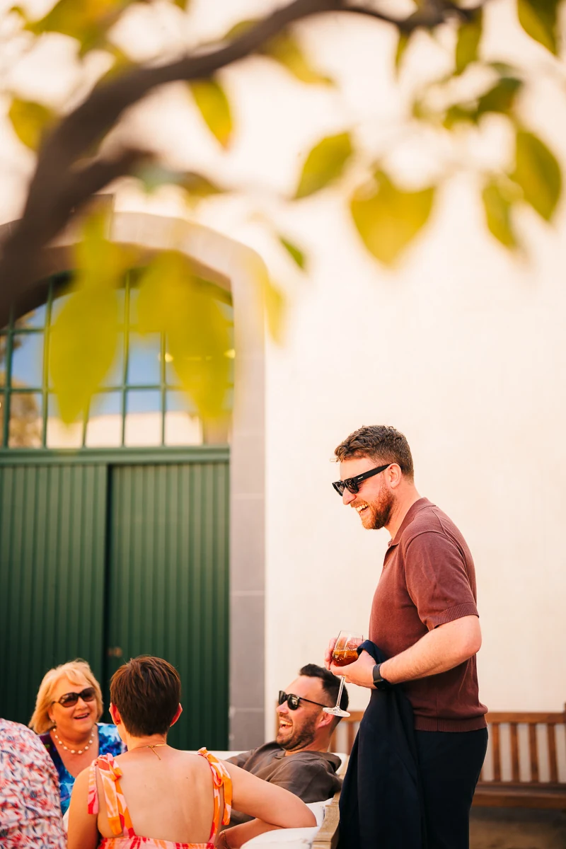 Guests gathering outside the venue entrance in the sunlight