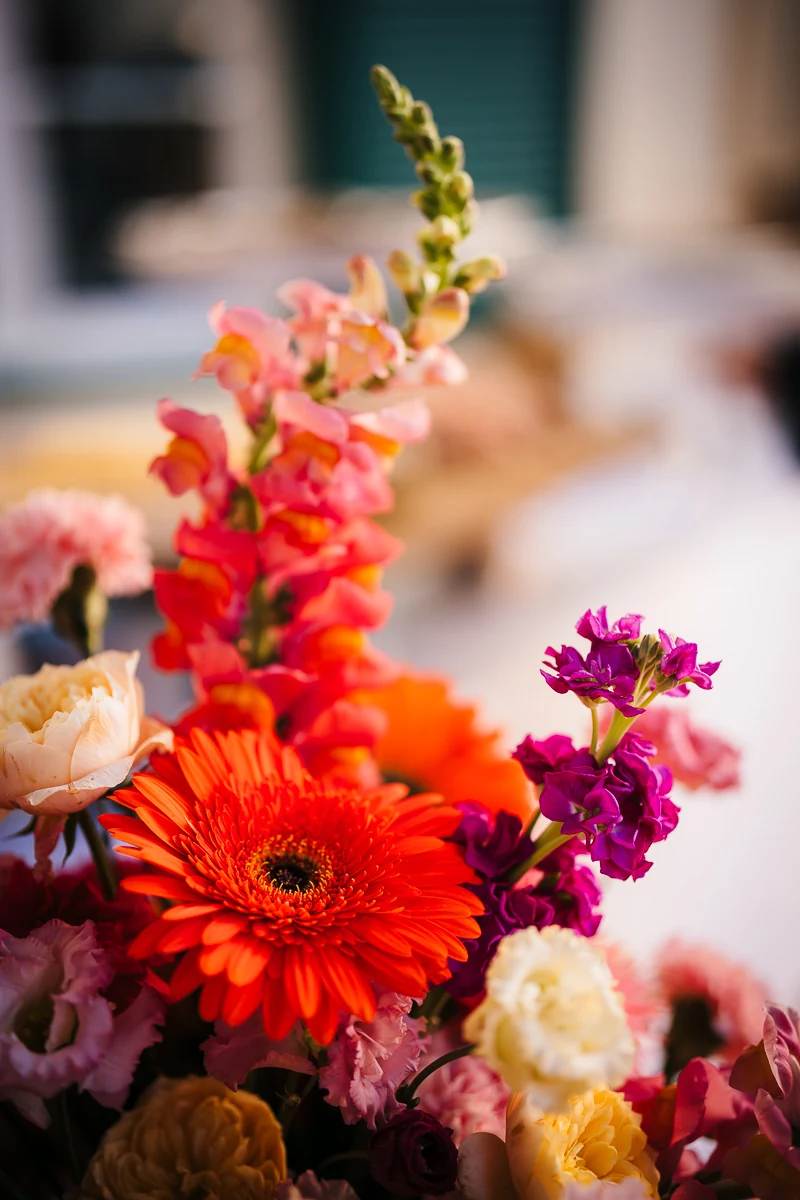 Orange and pink flower arrangement by fustaq floral