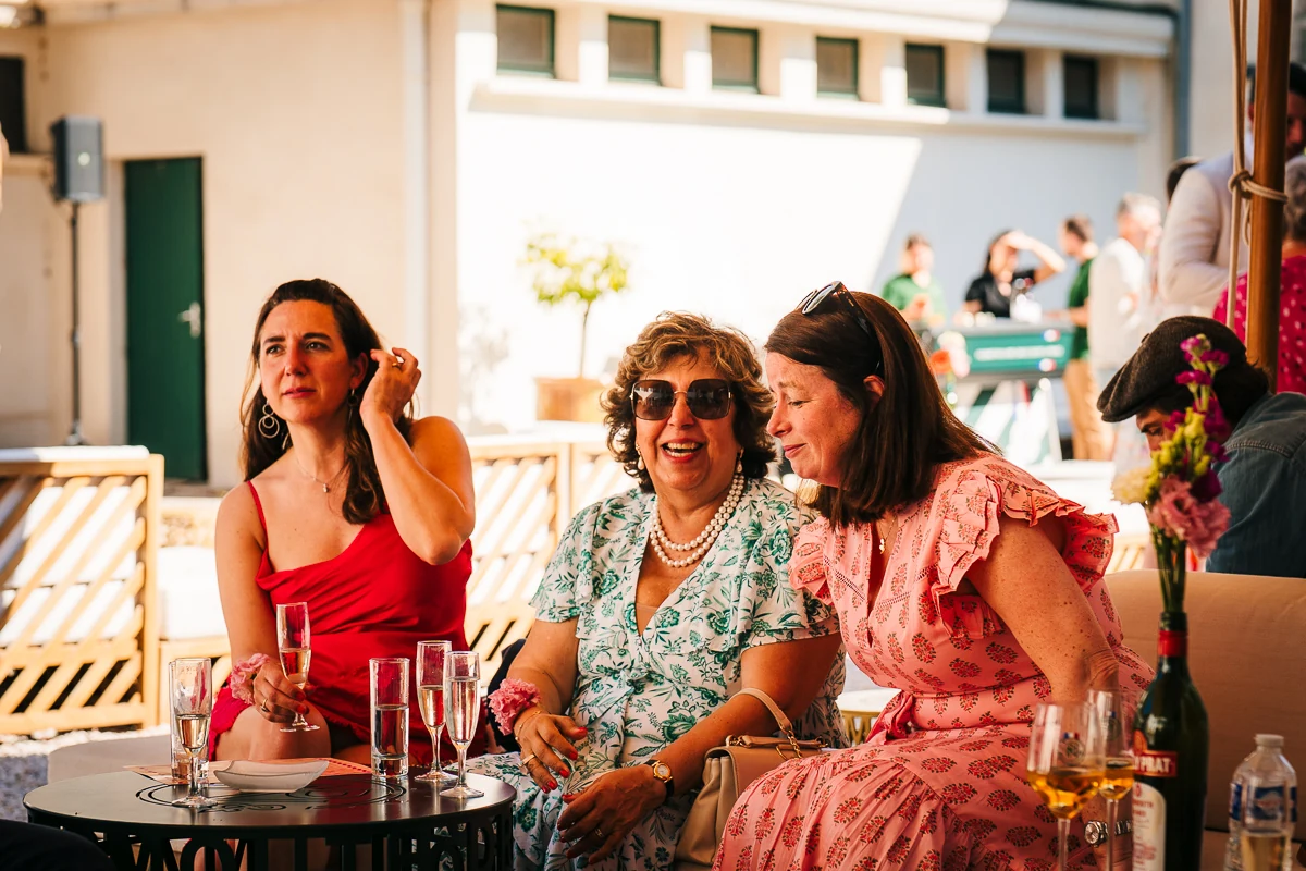 Group of women laughing together at an outdoor table