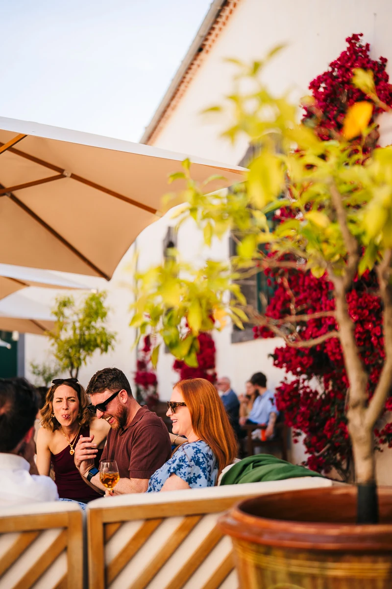 Guests relaxing under a shaded terrace decorated with flowers