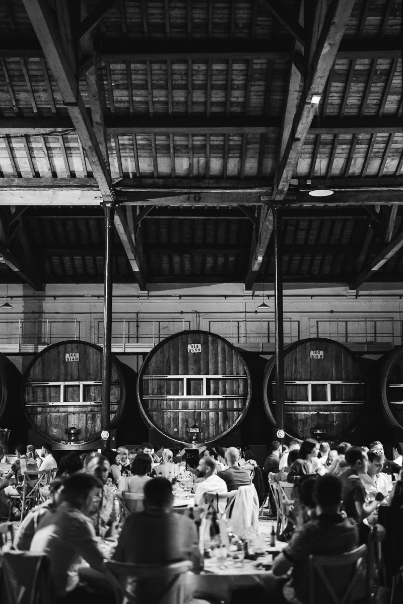 Guests seated for dinner in a barrel cellar reception venue