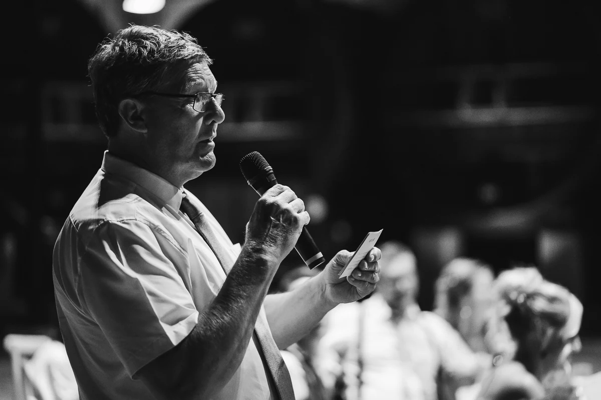Man giving a speech with a microphone during the reception