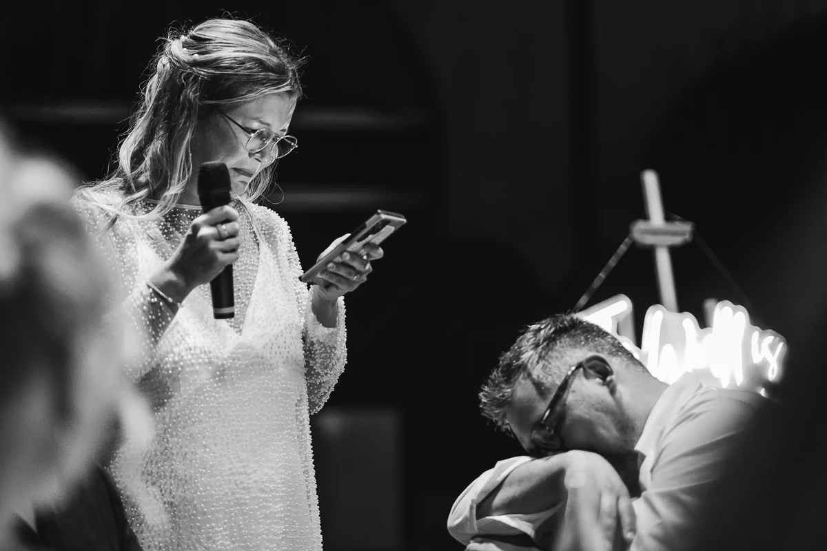 Bride giving a speech with a microphone during the reception