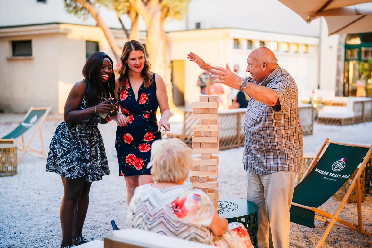 Guests playing a giant Jenga game at the wedding party