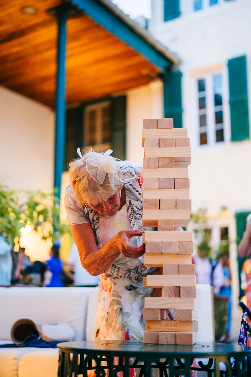 A grandmother focused on her game of giant Jenga