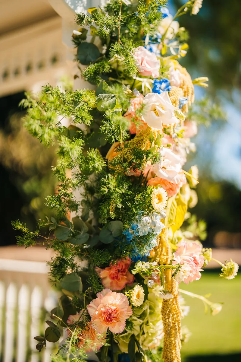 Close-up of pastel wedding flowers on the white bandstand at Domaine de la Trinité