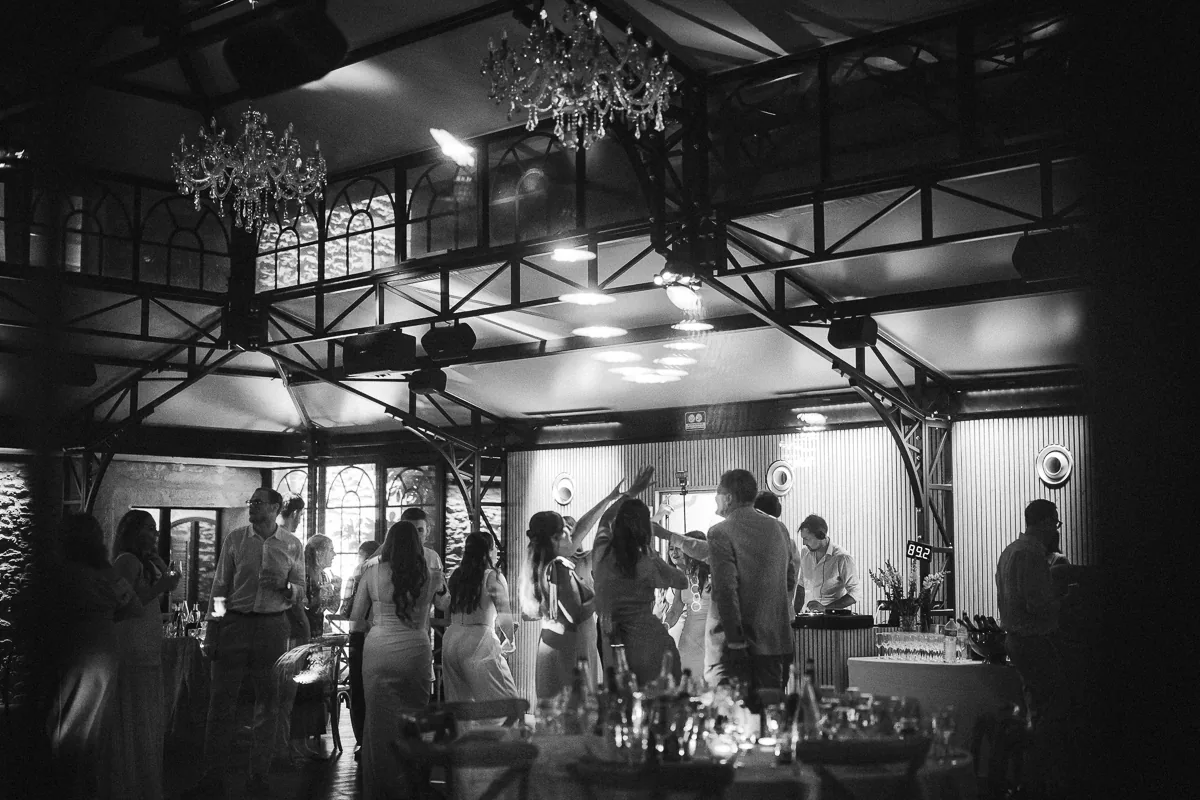 Black and white wide view of the dance floor in the orangery at Domaine de la Trinité