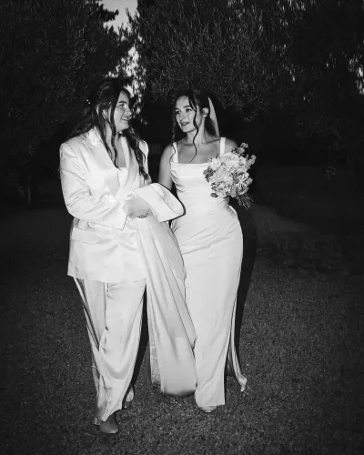Black and white flash portrait of two brides during an evening wedding photo session
